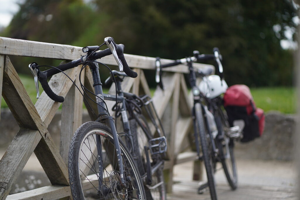 bike leaning on a wood bridge with bikepack