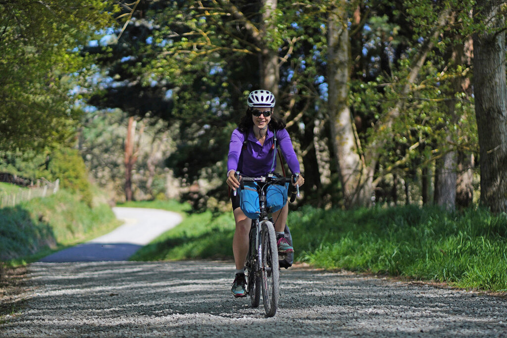 Bikepacking brevet cyclist, cycling on a road in New Zealand Aotearoa Hawkes Bay